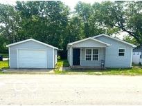 Charming single-story home featuring a detached garage and a welcoming front porch at 620 S 2Nd St, Noblesville, IN 46060