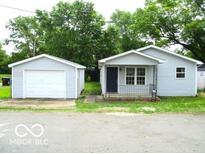 Charming single-story home featuring a detached garage and tidy front yard at 620 S 2Nd St, Noblesville, IN 46060