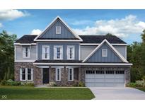 Charming two-story home boasts a stylish blend of brick and siding, complemented by a well-manicured lawn at 6894 Renoir Way, Avon, IN 46123