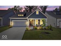 Charming single-Gathering home featuring a gray color scheme, well-manicured lawn, and attached garage at 7154 Covington St, Lebanon, IN 46052