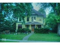 Charming two-story home with a well-manicured lawn and inviting front porch at 783 Woodruff Place Middle Dr, Indianapolis, IN 46201