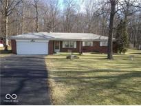 Charming single-story home with a brick facade, attached garage, and a well-maintained front yard at 8990 N 850 W, Fairland, IN 46126