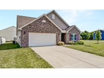 Charming brick home with a two-car garage and a well-maintained front lawn at 10112 James Run Dr, Indianapolis, IN 46239