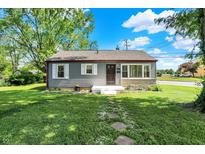 Charming one-story home with a well-maintained front yard and stone walkway at 11 14Th St, Franklin, IN 46131