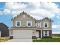 Charming two-story home with white trim windows, a two-car garage, and manicured lawn at 1304 Vera Blvd, Danville, IN 46122