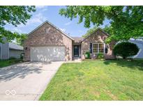 Charming single-story brick home with a well-maintained lawn and attached two-car garage at 13910 Brightwater Dr, Fishers, IN 46038