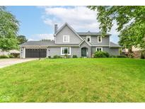 Charming two-story home featuring a well-manicured lawn, attached garage, and inviting front entrance at 164 Wellington Pkwy, Noblesville, IN 46060