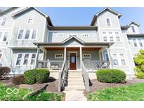 Inviting gray two-story home with covered porch and manicured landscaping at 2230 N Pennsylvania N St # 7, Indianapolis, IN 46205