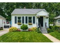 Charming home featuring well-manicured lawn, flower boxes and vibrant landscaping at 250 N 18Th Ave, Beech Grove, IN 46107