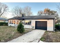 Charming single-story home with a well-maintained lawn and an attached garage at 4108 Patricia St, Indianapolis, IN 46222