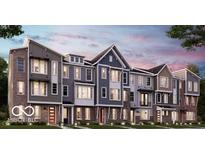 Modern townhome exteriors featuring brick and siding accents, multiple stories, and well-manicured landscaping at 7333 Bayview Run, McCordsville, IN 46055