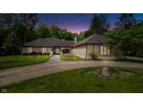 Stunning front exterior with a curved driveway, manicured lawn, and a home with unique architectural details at 7554 Silverpine Ct, Indianapolis, IN 46250