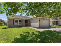 Charming one-story brick home with a well-maintained lawn and attached garage at 8447 Wanda Lake Dr, Camby, IN 46113