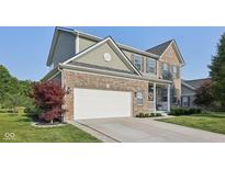 Charming brick and siding home with a two-car garage and a well-manicured front yard at 9840 N Anchor Bnd, McCordsville, IN 46055