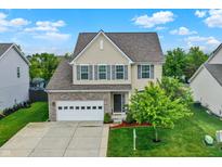 Charming two-story home featuring a stone facade, attached garage, and a well-manicured lawn and garden at 10306 Mcclain Dr, Brownsburg, IN 46112