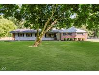 Charming ranch-style home featuring a well-manicured lawn and mature trees at 11802 Prairie Pl, Carmel, IN 46033