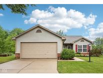 Charming single-story home featuring neutral siding, a two-car garage, and a beautifully landscaped front yard at 12207 Blue Sky Dr, Fishers, IN 46037