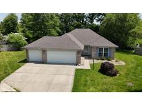 Charming single-story home with a two-car garage and well-maintained lawn at 1819 Quiet Haven Cir, Indianapolis, IN 46229
