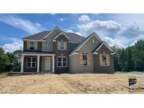 Charming new two-story home showcasing brick and stone accents, complemented by stylish shutters and an inviting front entrance at 1919 Delp Ct, Avon, IN 46123
