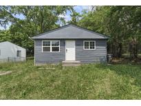 Charming exterior view of home featuring a well-manicured lawn and a neatly painted facade at 1948 Bloyd Ave, Indianapolis, IN 46218