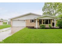 Charming single-story home with a well-manicured lawn and attached garage at 2925 E 8Th St, Anderson, IN 46012