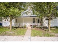 Charming home with a welcoming front porch, surrounded by mature trees, offers curb appeal at 307 E 5Th St, Sheridan, IN 46069