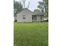 Quaint single-story home with gray siding and a well-maintained front lawn at 3439 Grant Ave, Indianapolis, IN 46218