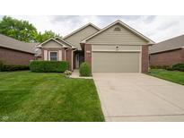 Charming single-story home featuring a brick facade, well-maintained lawn, and attached garage at 5352 Steinmeier N Dr, Indianapolis, IN 46220
