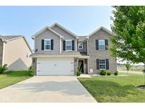 Two-story home with a well-manicured lawn, a two-car garage, and a combination of brick and siding at 680 Albermarle Dr, Pittsboro, IN 46167