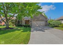 Charming brick home with a well-manicured lawn, mature tree, and attached two-car garage at 716 Royal Troon Ct, Avon, IN 46123