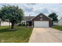 Charming single-story brick home with mature landscaping and a two-car attached garage at 7175 Oakview Dr, Avon, IN 46123