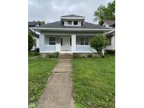 Charming home with a walkway leading to the front door at 802 N Oakland Ave, Indianapolis, IN 46201