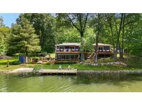 Beautiful lakeside home with a private dock and lush green surroundings at 8426 N Chickadee Dr, Morgantown, IN 46160