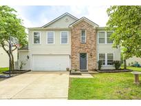Charming two-story home featuring a brick facade, well-manicured lawn, and a basketball hoop over the driveway at 10197 Apple Blossom Cir, Fishers, IN 46038