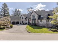 Charming brick home with a manicured lawn and mature trees at 11931 Promontory Ct, Indianapolis, IN 46236