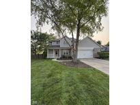 Charming two-story home with brick accents, a well-manicured lawn, and mature shade trees at 1378 Runningbrook Dr, Avon, IN 46123