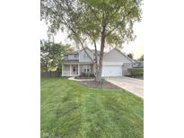 Charming two-story home with a well-manicured lawn, inviting porch, and a two car garage at 1378 Runningbrook Dr, Avon, IN 46123