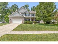 Charming two-story home with a well-manicured lawn and inviting front porch at 1696 Woodfield Dr, Greenwood, IN 46143
