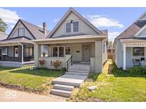 Charming home featuring a gabled roof, inviting front porch, and well-manicured lawn at 1709 Fletcher Ave, Indianapolis, IN 46203