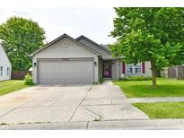 Charming single Gathering home with a well maintained lawn and concrete driveway leading to a two car garage at 3429 Pavetto Ln, Indianapolis, IN 46203