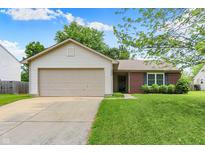 Charming single-story home featuring a brick facade, attached two-car garage, and well-maintained lawn at 4007 Knollwood Ave, Franklin, IN 46131