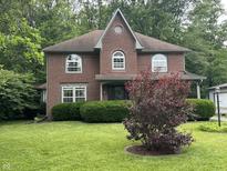 Charming brick home with well-manicured lawn and mature landscaping at 5010 Melbourne Rd, Indianapolis, IN 46228