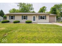 Charming ranch-style home featuring a well-maintained lawn, blue shutters, and an attached one car garage at 6408 Old Mill Dr, Indianapolis, IN 46221