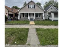 Charming home featuring a covered front porch with decorative columns and a well-maintained lawn at 733 Haugh St, Indianapolis, IN 46222
