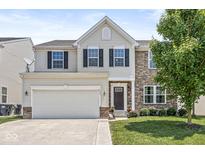 Charming two-story home with a two-car garage, stone accents, and well-maintained landscaping at 733 Reunion Ln, Greenwood, IN 46143