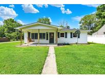 Charming single-story home with a covered front porch and a lovely swing for relaxing at 7455 W 700 N, Fairland, IN 46126