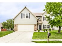 Charming two-story home with a well-manicured lawn and attached two-car garage at 7546 Kidwell Dr, Indianapolis, IN 46239