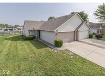 Well-maintained home featuring a two-car garage, manicured lawn, and charming curb appeal at 824 Ashton Park Dr, Greenwood, IN 46143