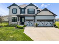 Beautiful two-story home featuring a well-manicured lawn, and a two-car garage at 8635 Verbena Rd, Zionsville, IN 46077