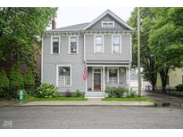 Charming two-story home featuring a classic design, inviting porch, and well-maintained landscaping at 1512 Bellefontaine St, Indianapolis, IN 46202
